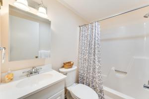 a bathroom with a sink and a toilet and a mirror at Renovated Ski-InandSki-Out Peru Condo at Bromley Mtn in Peru +21 photos