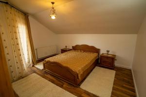 a bedroom with a bed and two night stands at Vila Zona Centrală in Zalău