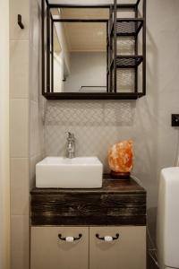 a bathroom with a sink and a mirror at Von Aghte Small Studio in Kuressaare +16 photos