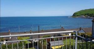 a view of the ocean from a balcony at Ferns Holiday let in Glenarm