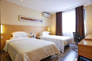 a hotel room with two beds and two lamps at City Comfort Hotel Kuala Lumpur City Center (Bukit Bintang) in Kuala Lumpur
