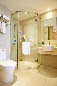 a bathroom with a shower and a toilet and a sink at City Comfort Hotel Kuala Lumpur City Center (Bukit Bintang) in Kuala Lumpur