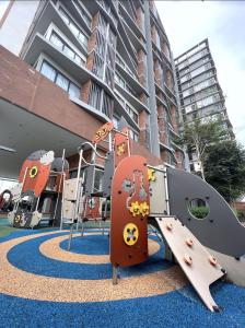 a playground in front of a building with a slide at BELLSUITE SEPANG NEAR KLIA Airport in Sepang