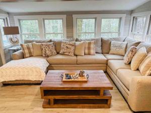 a living room with a couch and a coffee table at Lakefront Cottage on Brewer Lake in Holden