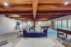a living room with a blue couch and a table at Historic White Manor in Timonium