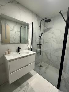 a white bathroom with a sink and a shower at Belle maison, 15mn de Paris, 2 parkings gratuits in Cachan +60 photos