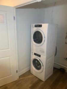a washer and dryer sitting in a laundry room at Beachview getaway at the New Carlyle 304 on the Main strip in Grand Bend in Grand Bend