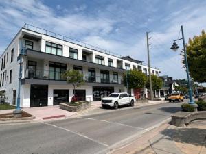 a white car parked in front of a building at Beachview getaway at the New Carlyle 202 on the Main strip in Grand Bend in Grand Bend