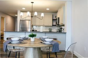 a dining room and kitchen with a table and chairs at Beachview getaway at the New Carlyle 202 on the Main strip in Grand Bend in Grand Bend