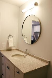 a bathroom with a sink and a mirror at Beachview getaway at the New Carlyle 202 on the Main strip in Grand Bend in Grand Bend +19 photos