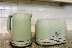 a green coffee maker sitting on top of a counter at Beachview getaway at the New Carlyle 202 on the Main strip in Grand Bend in Grand Bend