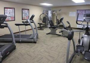 a gym with several treadmills and exercise bikes at Suburban Studios Washington, PA in Washington