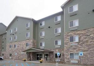 a large apartment building with a parking lot at Suburban Studios Washington, PA in Washington