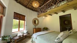 a bedroom with a bed and a window and a mirror at Frog Mountain Getaway in Swellendam +88 photos