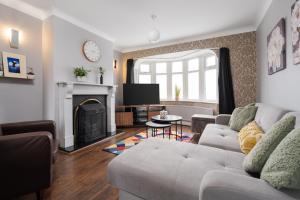 a living room with a couch and a fireplace at Manchester Business and Leisure Home with Free Parking in Manchester