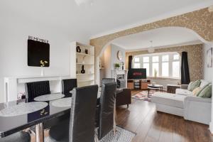 a dining room and living room with a table and chairs at Manchester Business and Leisure Home with Free Parking in Manchester