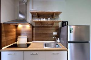 a small kitchen with a sink and a refrigerator at Villa Maria apartments in Nea Skioni
