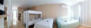 a white room with two beds in it at Pousada Belo Recanto - Pipa in Pipa +56 photos