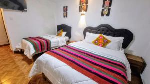 Postel nebo postele na pokoji v ubytování Mallku Wasi - Lodging Hotel Cusco