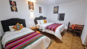 Postel nebo postele na pokoji v ubytování Mallku Wasi - Lodging Hotel Cusco