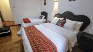 Postel nebo postele na pokoji v ubytování Mallku Wasi - Lodging Hotel Cusco