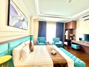 a hotel room with a large bed and a television at Grand Ha Noi Hotel in Hanoi