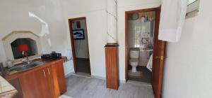 a bathroom with a sink and a toilet at Domek w lesie in Łopuszno +15 photos