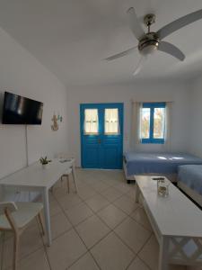 a living room with a couch and a blue door at Milithos Apartments 1 in Adamantas