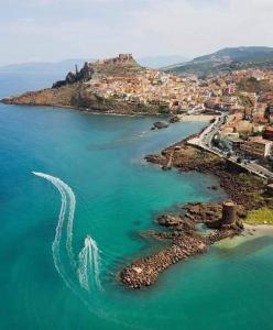 an aerial view of a beach with a boat in the water at Best Western Hotel Blumarea in Castelsardo