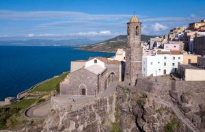 a church on the edge of a cliff with the ocean at Best Western Hotel Blumarea in Castelsardo