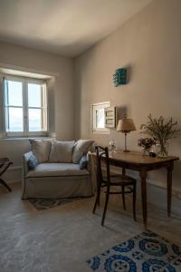 a living room with a couch and a table at Tonnara di Scopello in Castellammare del Golfo