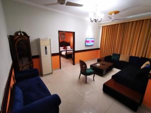 a living room with a couch and a table at Walk-Inn Apartments F-11 Islamabad in Islamabad