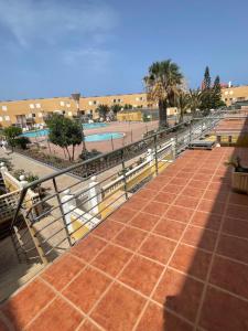 a walkway next to a swimming pool with benches at Casa Bonita in Costa de Antigua