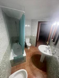 a bathroom with a tub and a toilet and a sink at Casa Bonita in Costa de Antigua +10 photos