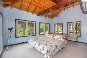 a bedroom with a bed and a camera at Mountain House Palmetto Bay with Private Pool in Roatan +33 photos