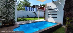 a swimming pool in the backyard of a house at Casa Guacamayas in Tlatenchu