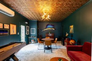 a living room with a ping pong table at Downtown Os Artistic Stay W Fire Pit, Game Room! in Ocean Springs