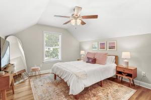 a bedroom with a bed and a ceiling fan at Downtown Os Artistic Stay W Fire Pit, Game Room! in Ocean Springs
