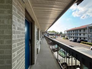a balcony with a blue door and a building at Motel 6 Charlotte, NC Northlake in Charlotte