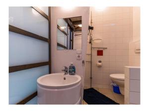 a bathroom with a sink and a toilet and a mirror at Ferienhaus Sommerlust in Borkum +8 photos