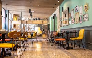 a restaurant with tables and chairs in a room at Hôtel Royal - Centre Comédie in Montpellier