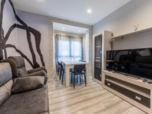 a living room with a couch and a television and a table at Gran Bilbao XII by Aston Rentals in Barakaldo