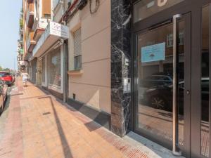 a store window with a reflection of a car in a street at Gran Bilbao XII by Aston Rentals in Barakaldo