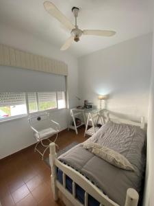a bedroom with a bed and a ceiling fan at Casa centro Urquiza in Gualeguaychú