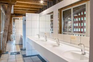 a bathroom with three sinks and a mirror at Campingplatz Mauterndorf in Mauterndorf