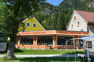 a yellow and orange building in front of a building at Campingplatz Mauterndorf in Mauterndorf