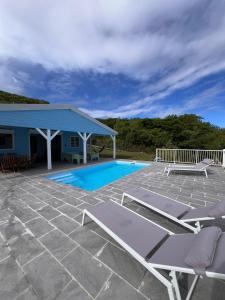 a patio with chairs and a swimming pool at Villa petite Quiétude in Cap Chevalier +13 photos