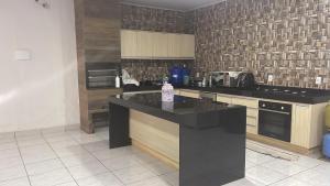 a kitchen with a black counter top in a room at Comfort and Style Master Ebony I in Cuiabá +16 photos