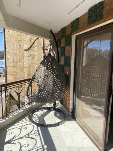 a basket on a balcony with a window at شقة فندقية مفروشة فخمة in Cairo