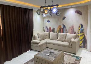 a living room with a couch and a table at شقة فندقية مفروشة فخمة in Cairo